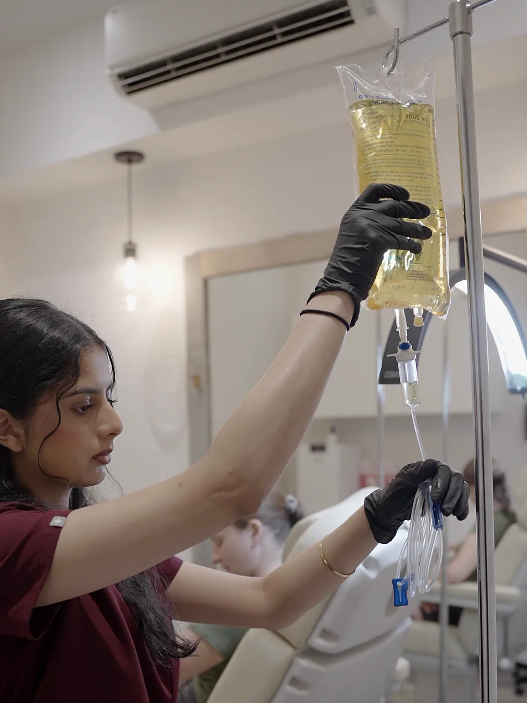 A nurse hanging an IV bag at Balanced Health & Wellness