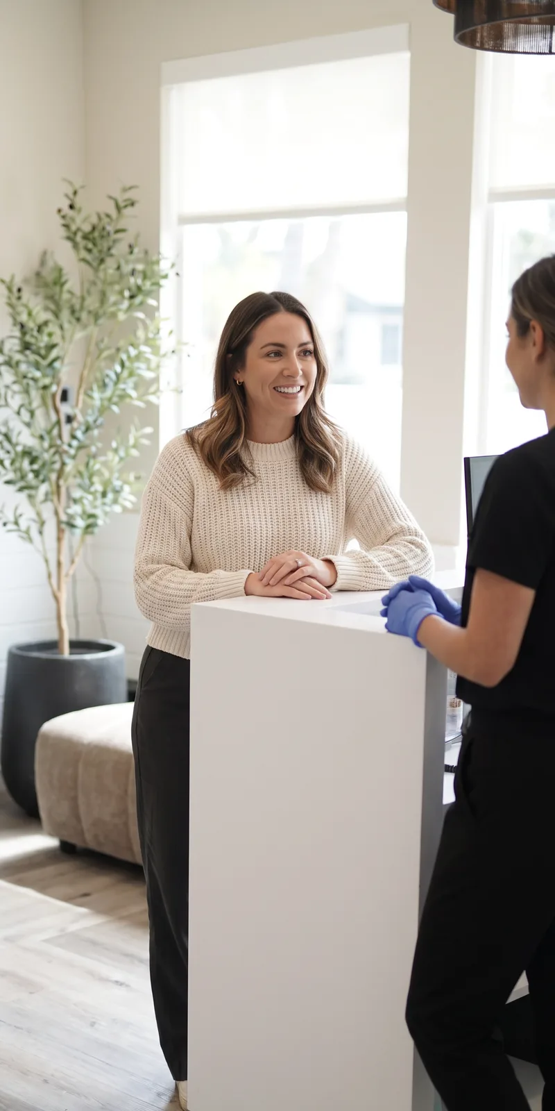 A patient asking a question at the front desk