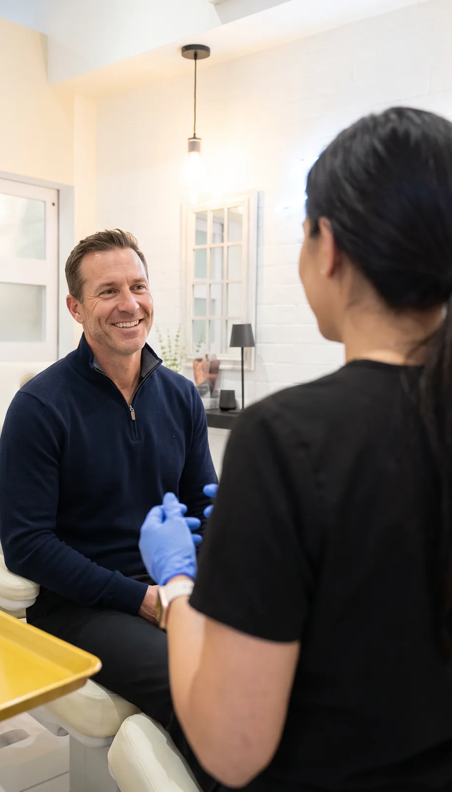 A man in his 40s talking with a clinician at Balanced Health & Wellness